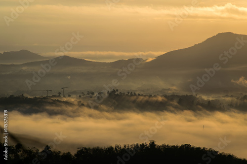 Beautiful summer sunrise on the top of mountain with Rays of Light, fog and cloud mountain