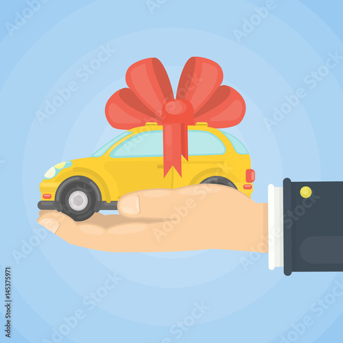 Car gift on hand. Yellow car with red ribbon.