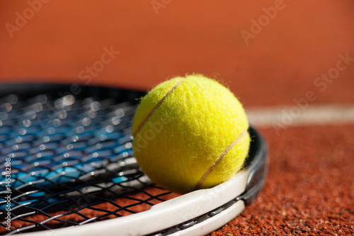 Tennis racket and ball on court  © bbstudio_ada