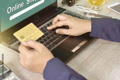 Hands holding credit card and using laptop. Online shopping concept