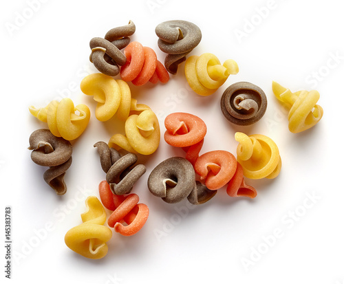 Three-colored pasta isolated on white, from above