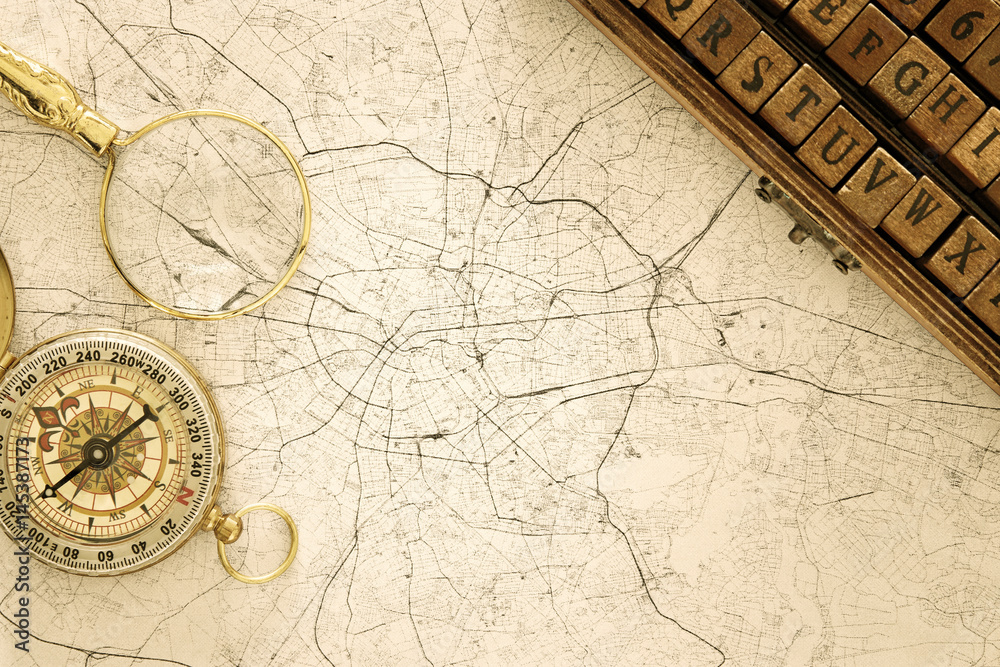 Naklejka premium Image of map, magnifying glass and old compass. selective focus
