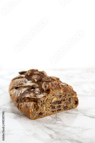 Fresh home made bread with nuts and dry fruits on marble background