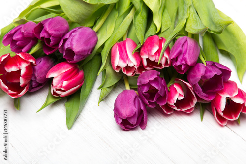 Tulip bouquet on white wooden background  copy space