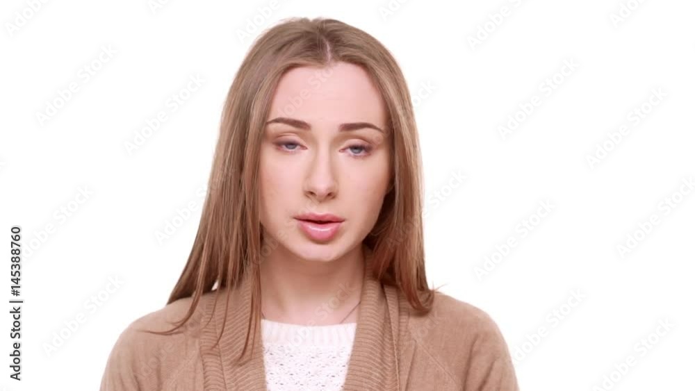 Surprised beautiful Caucasian female standing in amuzement on white background in slowmotion Surprised beautiful Caucasian female standing in amuzement on white background in slowmotion
