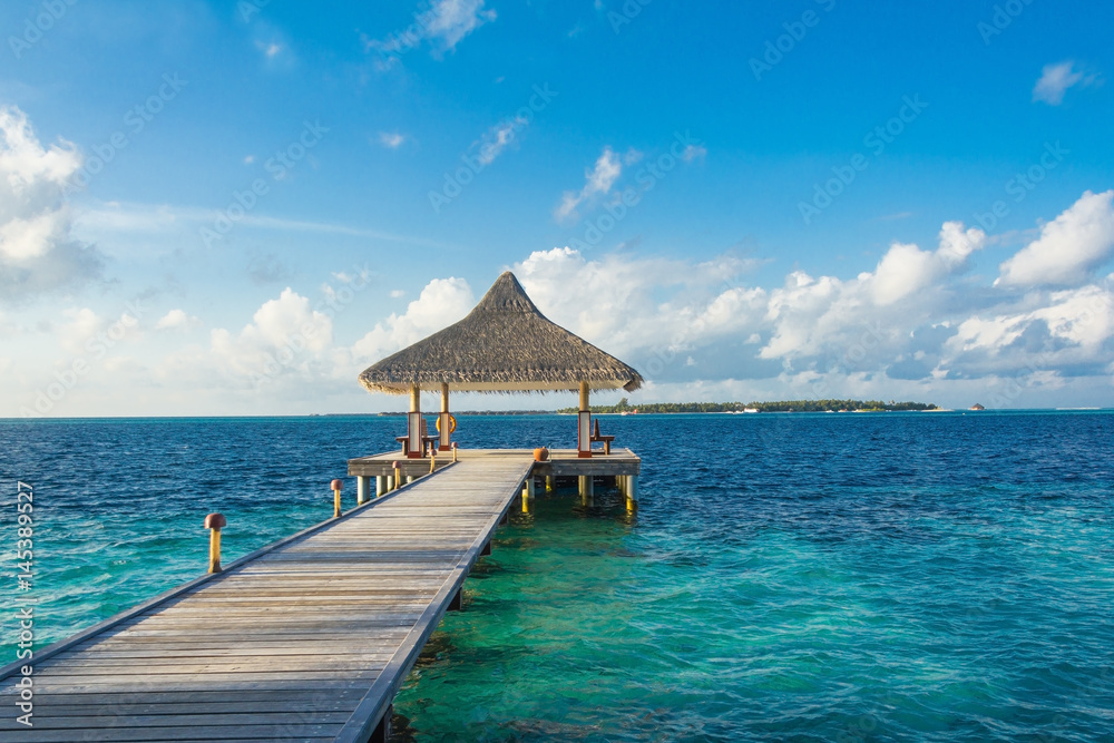 Wooden pier on a tropical beach in the Maldives
