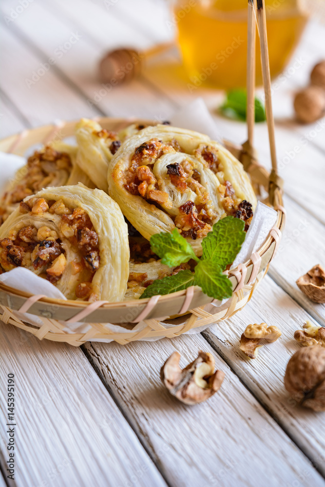 Baked rolls stuffed with walnuts, raisins and honey