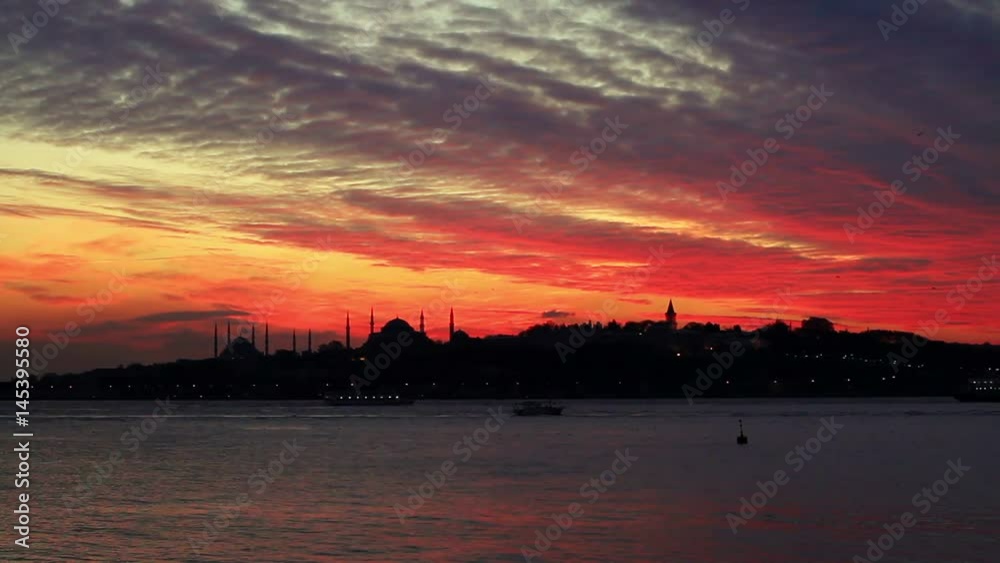 Sunset behind the historical peninsula. Breathtaking view over shimmering waters of Istanbuls magnificent Bosphorus. Cruise past ornate Ottoman palaces, grand villas, mosques and mansions. Great domes Sunset behind the historical peninsula. Breathtaking view over shimmering waters of Istanbuls magnificent Bosphorus. Cruise past ornate Ottoman palaces, grand villas, mosques and mansions. Great domes