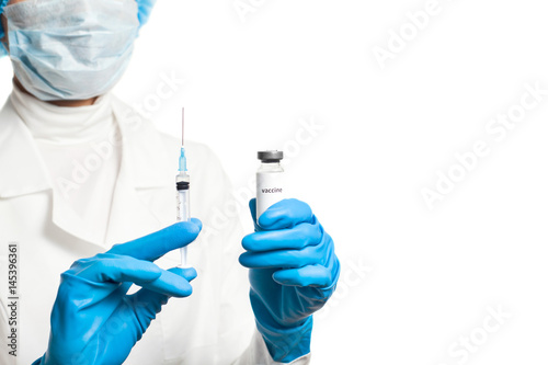 Medic holding syringe and capsule with vaccine in hand isolated on white. Vaccination. Influenza