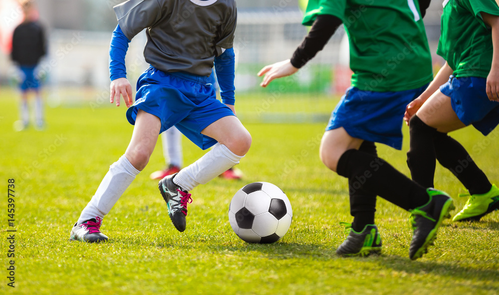 Football Soccer Match for Children. Kids Playing Soccer Game Tournament. Boys Running and Kicking Football Ball. Soccer Pitch in the Background