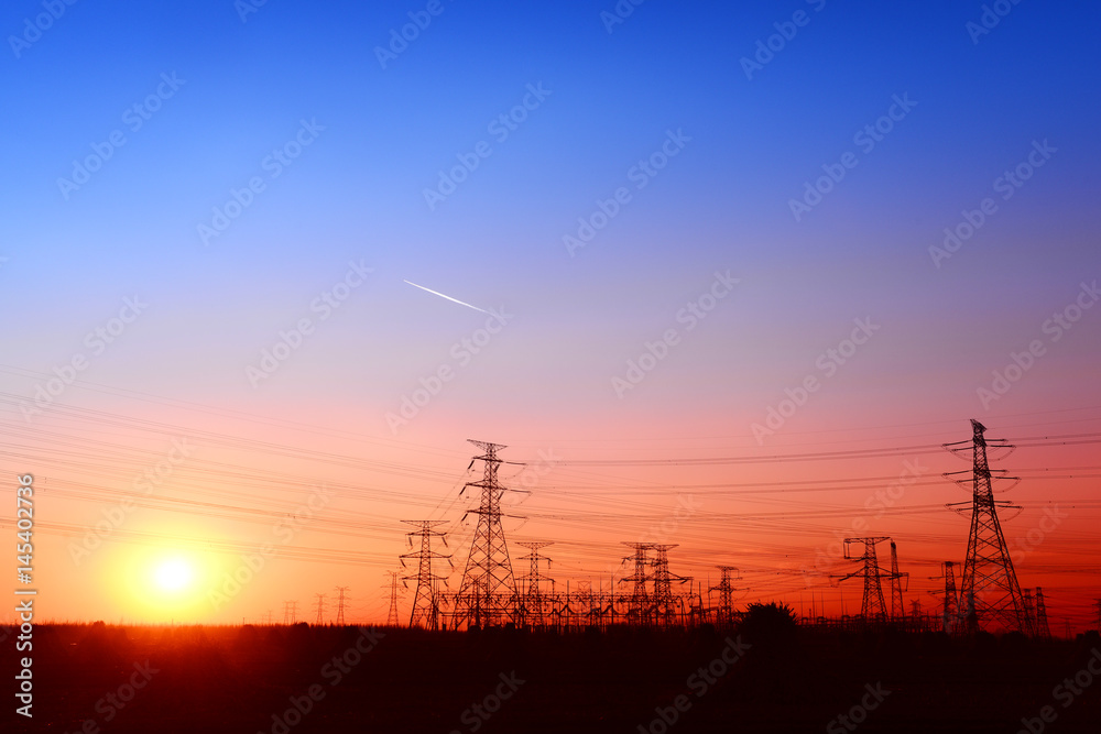 Fototapeta premium High voltage towers, under the setting sun