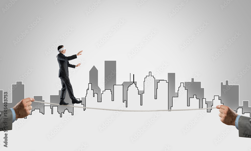 Business concept of risk support and assistance with man balancing on rope