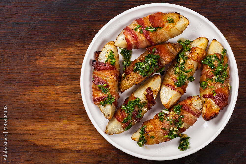 Bacon Wrapped Potatoes with Parsley Garlic Pesto Sauce. Selective focus. Bacon Wrapped Potatoes with Parsley Garlic Pesto Sauce. Selective focus.