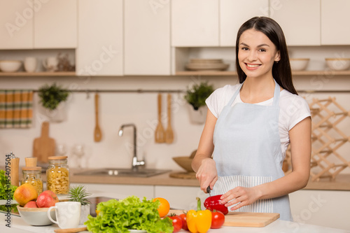 Young Woman Cooking in the kitchen. Healthy Food. Dieting Concept. Healthy Lifestyle. Cooking At Home. Prepare Food