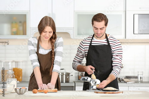 Young couple preparing past...