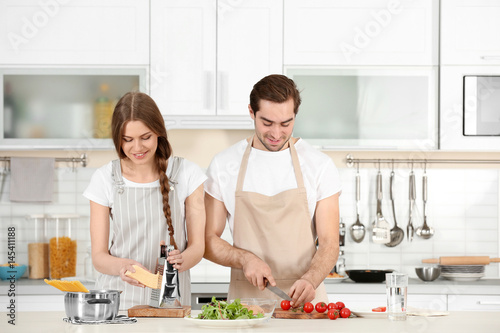 Young couple preparing past...