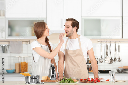 Young couple preparing past...