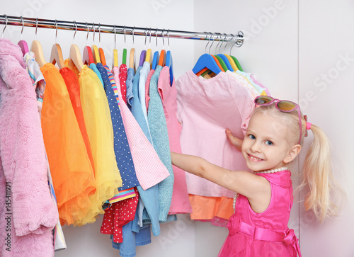 Cute small girl in wardrobe...