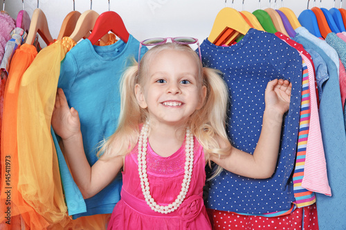 Cute small girl in wardrobe...