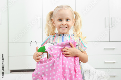 Cute small girl with clothe...