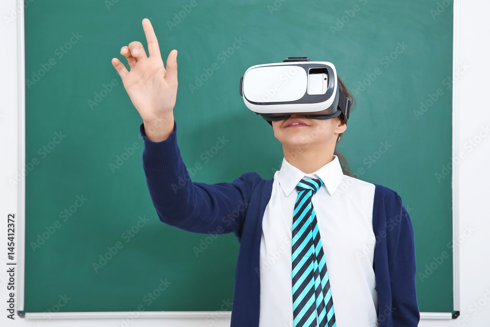Schoolgirl with virtual reality glasses in classroom Schoolgirl with virtual reality glasses in classroom