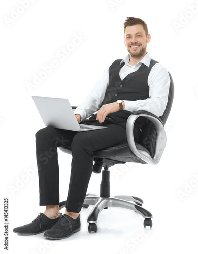 Handsome young man with lap...