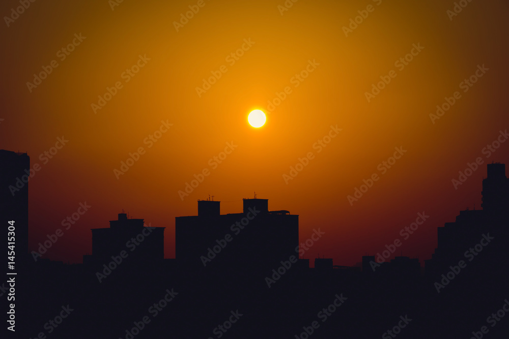 Building silhouette against sunset sky. Vignetting effect.