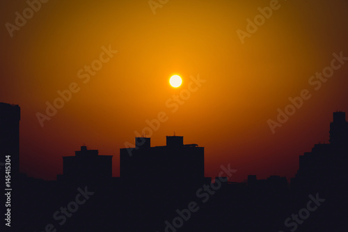 Building silhouette against sunset sky. Vignetting effect.