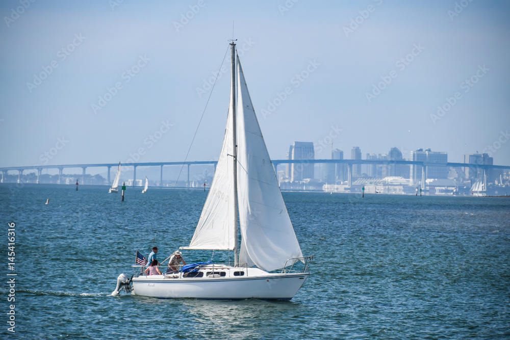 Sailboat cruising at San Diego bay for weekend leisure Sailboat cruising at San Diego bay for weekend leisure