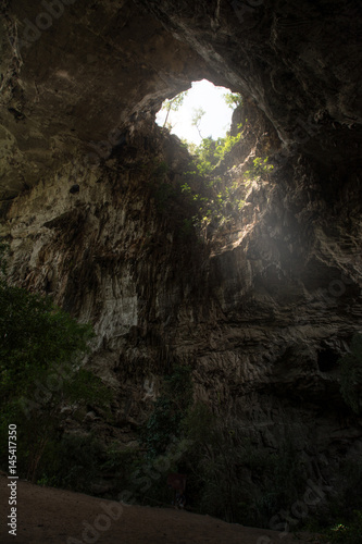 Sunlight shines through the Than Lot Yai Cave ( Chaloem Rattanakosin National Park ) , Kanchanaburi, Thailand