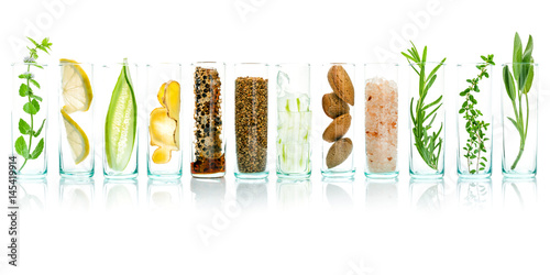 Homemade skin care with natural ingredients aloe vera, lemon, cucumber, himalayan salt, peppermint, rosemary, almonds, cucumber, ginger and honey pollen isolated on white background.