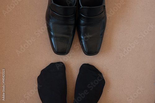 feet with black socks and black shoes