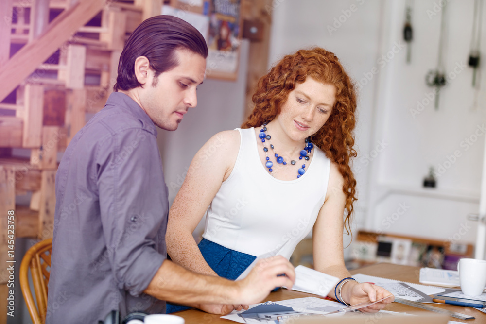 Obraz premium Two young architects in office