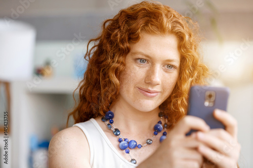 Happy beautiful young businesswoman using smart phone smiling
