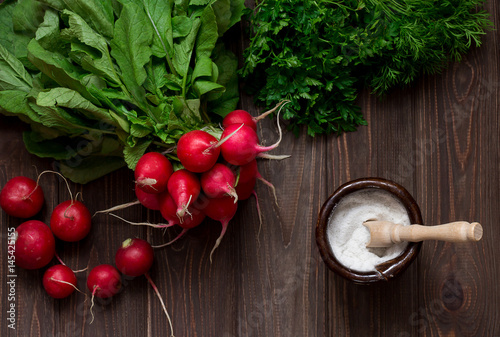 Fototapeta Naklejka Na Ścianę i Meble -  Radish, Herbs and salt on a wooden table.