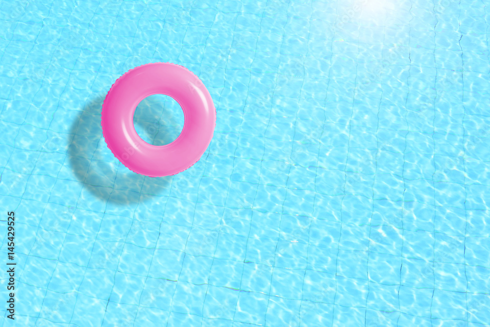 Naklejka premium pink swimming pool ring float in blue water. concept color summer.