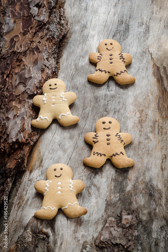 Happy gingerbread people on aged wood