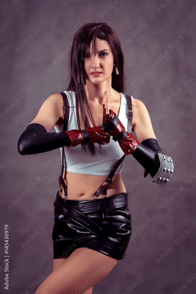 Young woman posing as superhero or superwoman Young woman posing as superhero or superwoman