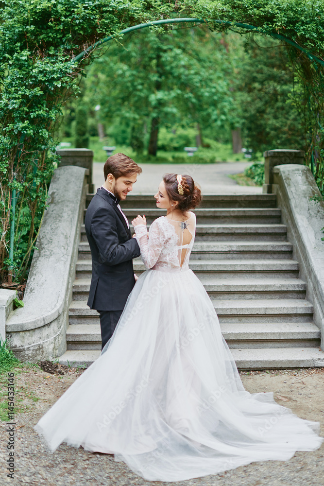 Portrait of bride and groom wedding walking in park