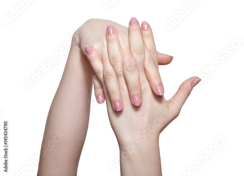 Female hands with woman's professional natursl pink nails manicure on white