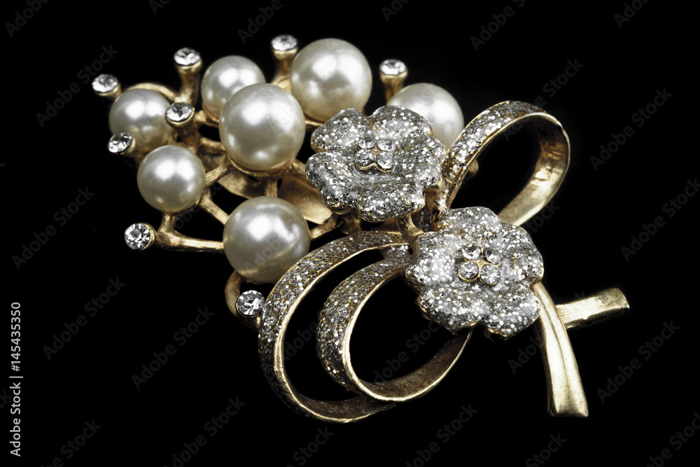 gold and white jewelry with dark background. low key picture style of commercial product. gold and white jewelry with dark background. low key picture style of commercial product.