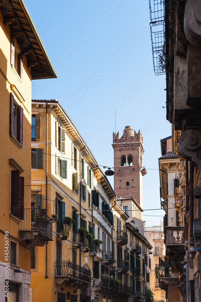 view of tower through street in Verona city