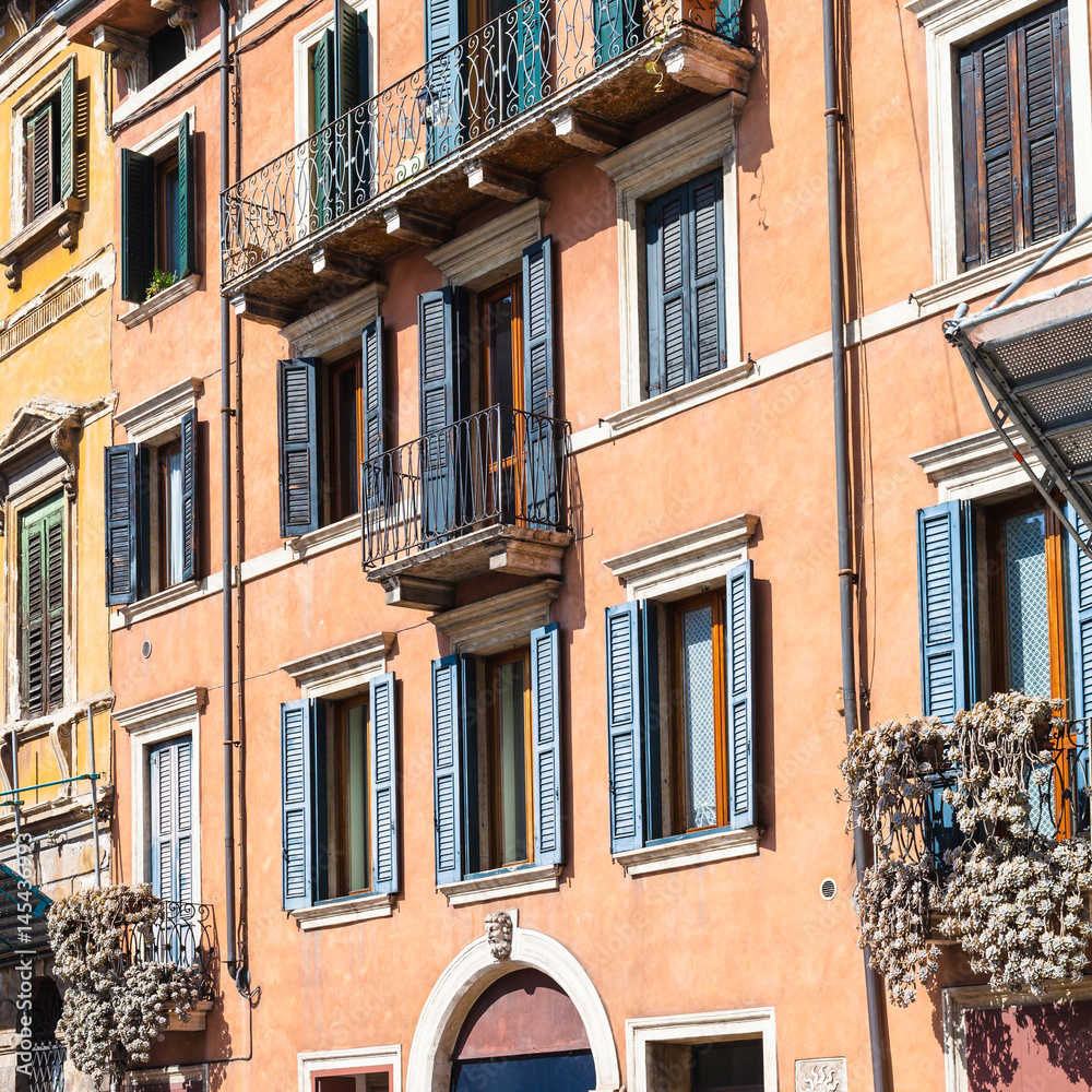 facade of old apartment houses in Verona city