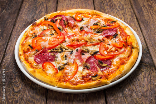 Delicious pizza with mushrooms and smoked chicken