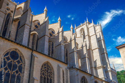 Side bottom view of Part of cathedral Saint Jean-Baptiste in Lyon, France. Summer day with clear blue sky and white clouds.