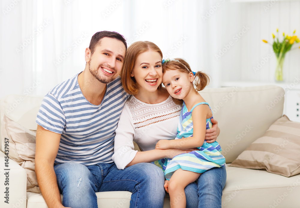 Happy family laughing and hugging at home on sofa Happy family laughing and hugging at home on sofa