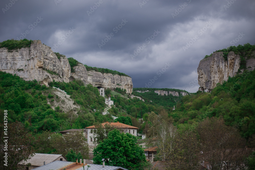 beautiful wild nature, the green trees, woods, high cliffs, caves, houses and castles, rain clouds summer