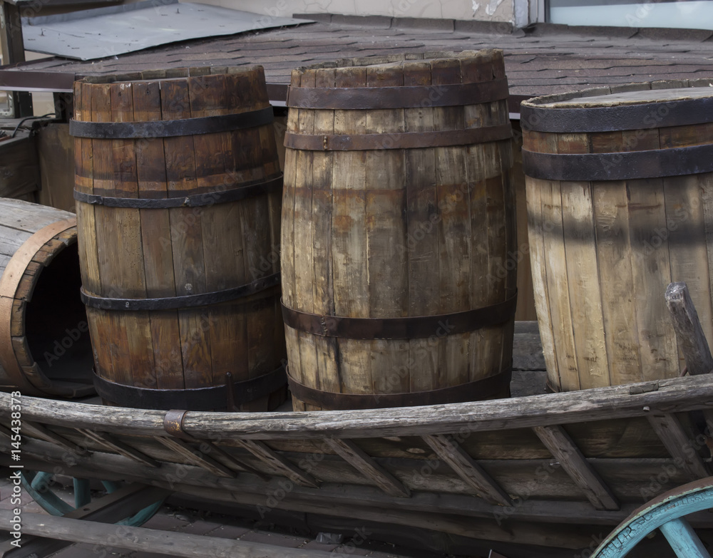 Wooden barrel with rust ferrule in the waggon. Wooden barrel with rust ferrule in the waggon.