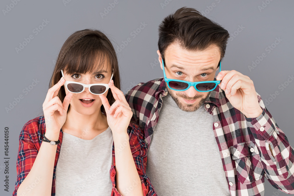 A pair of young people leave glasses and opens her mouth in surprise.