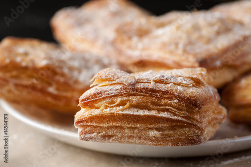 Canvas Print Detailed macro shot of delicious puff pastries in a white plate